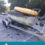 Red tagged sailboat on land in route to salvage yard Hudson Florida