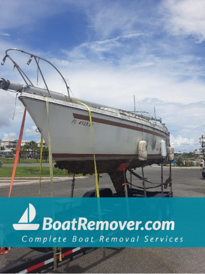 Sailboat strapped down to be disposed from Crawfordville, Florida